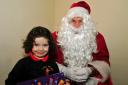 Three year old Ella May Johns tells Santa what she wants for Christmas.  Picture by Mark Davies (50238197)