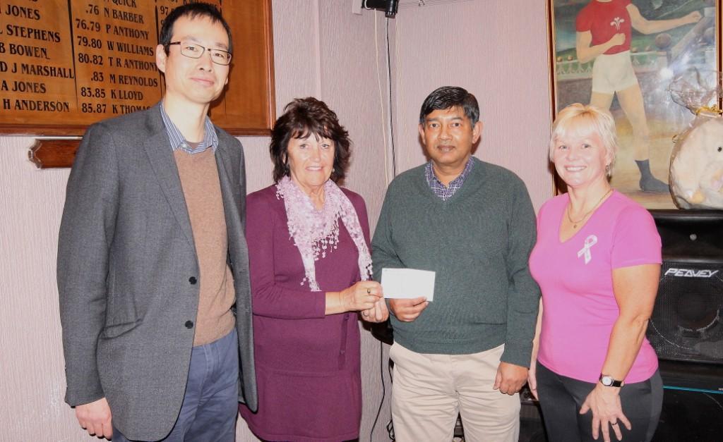 Mr Moosa and Yung Ung, consultants at Prostate Unit in Prince Philip Hospital, receive a cheque for £500. Pic: SDD