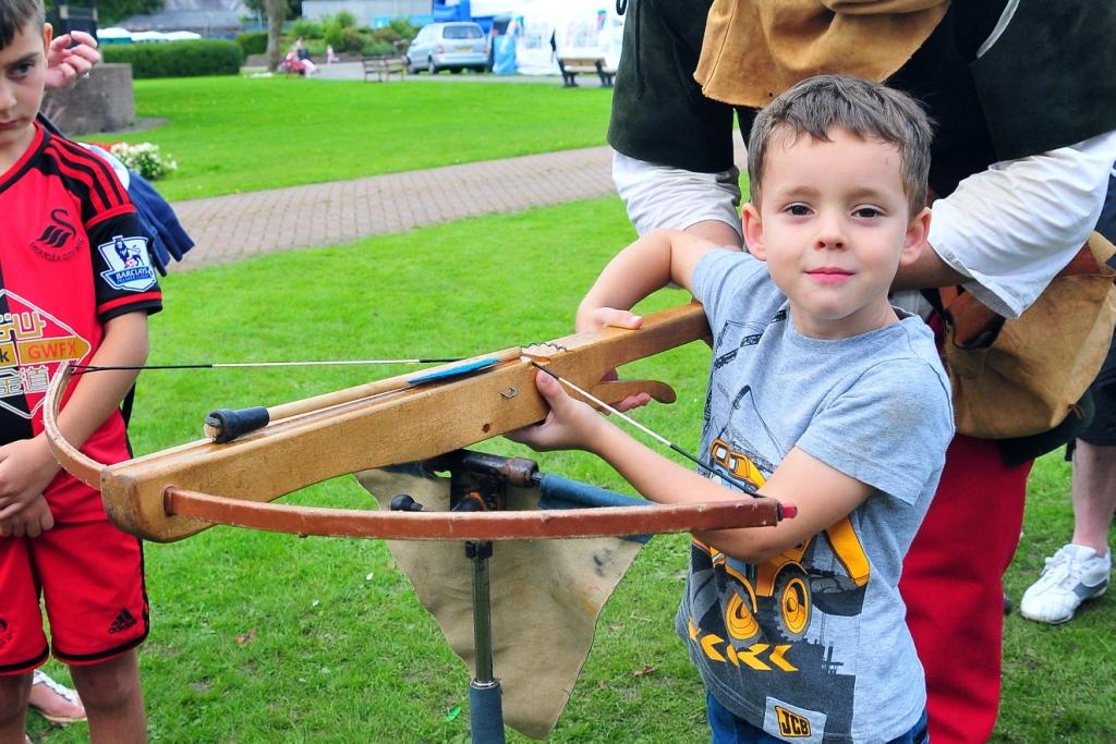 Five year old Bro Banw pupil Ewan Jones gets to grips with a crossbow.  Picture by Mark Davies