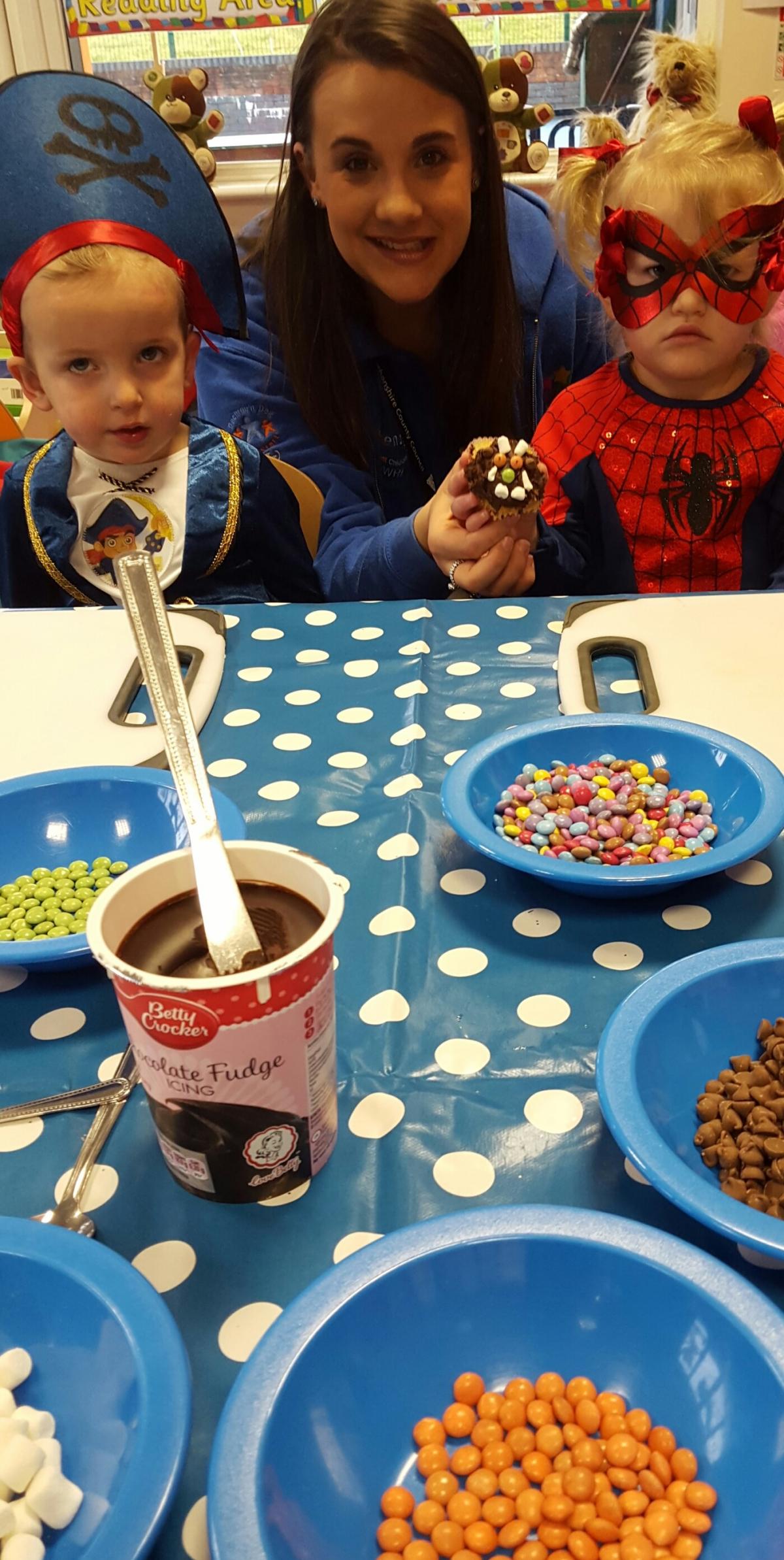 Codi and Lowri cannot wait to get their teeth into the lip smacking Gruffalo cup cakes at Ser Ni Flying Start nursery in Llwynhendy. Pic: Ron Cant