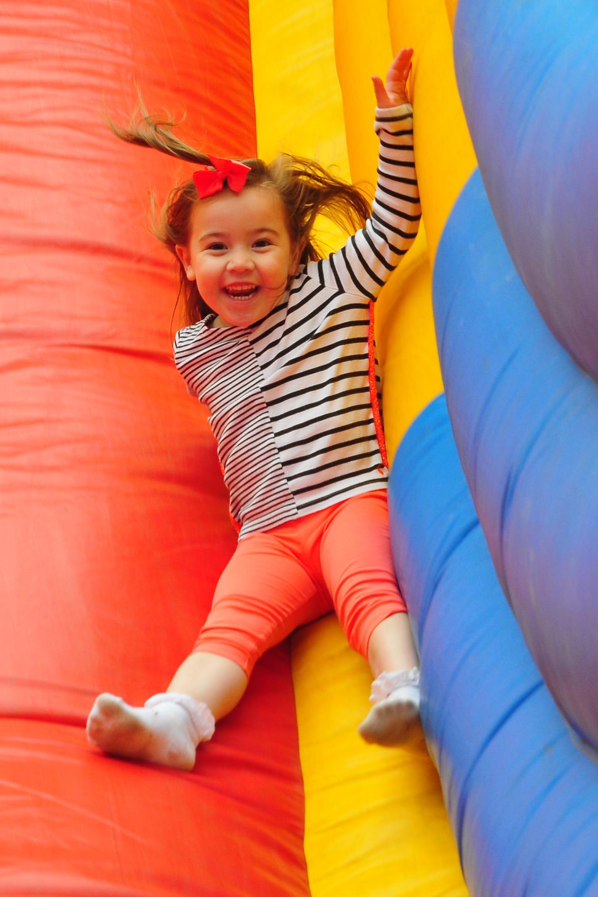 Three year old Mili Gwen has fun on the slide.