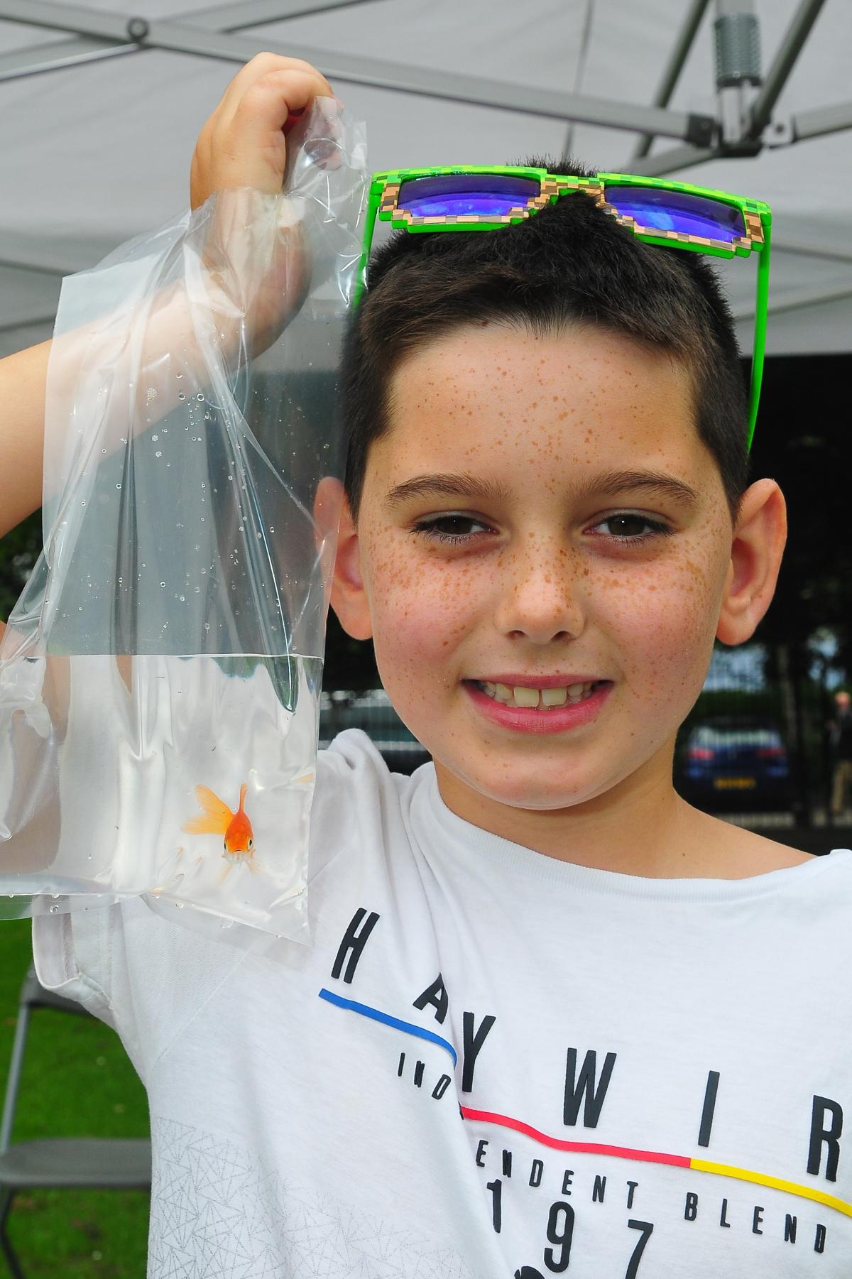 Nine year old Rhydian Jones shows off the gold fish he won at SFS.