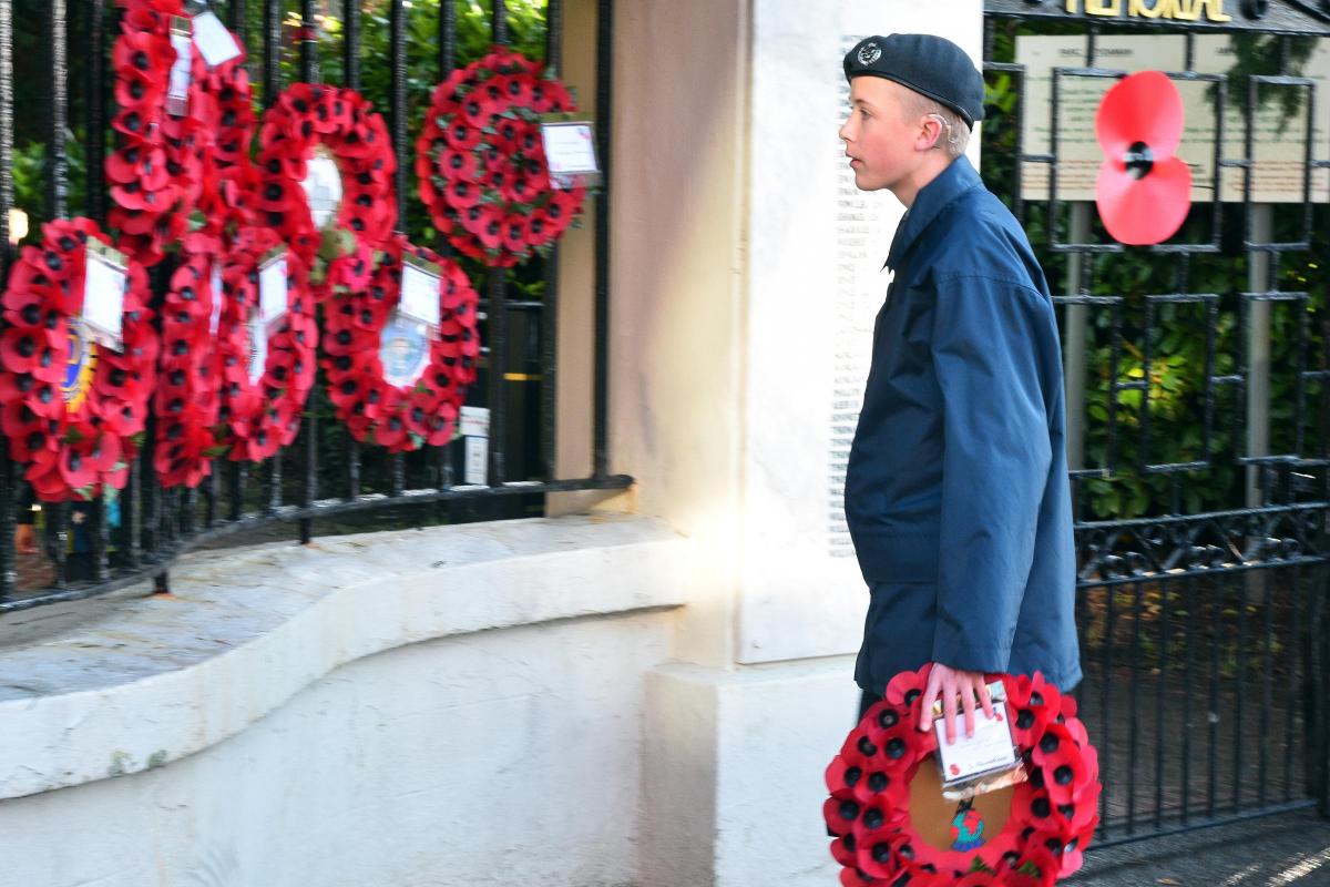 An air cadet places a wreath at Ammanford Memorial Gates.