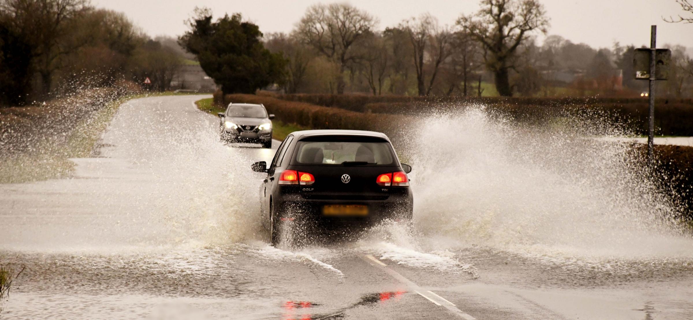 Motorists negotiate the flooded A40 near Llandeilo on Saturday Picture: Stuart Ladd