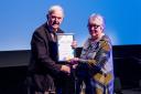 Cllr Peter Hughes Griffiths presenting a culture award to Dorothy Morris who was won of the winners in the Excellence of Visual Arts and Crafts.