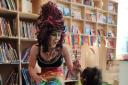 Drag Queen Aida H. Dee captivating kids in one of her story readings.