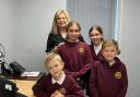 Some of Llandybie Primary School's pupils at the Ammanford Ashmole & Co office with Laura Craddock