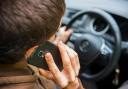 Two people fined for using mobile phone behind wheel. Picture: Canva