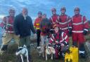 Maude and her canine companions are pictured with the rescuers from Pontardawe fire station.