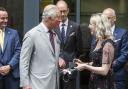 Mari Thomas giving then-Prince Charles a pair of cufflinks.