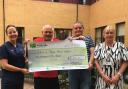 Henry and Roy Owen (centre) presenting cheque to unit at Prince Philip Hospital. Picture: Hywel Dda Health Charities