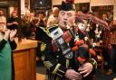 Pipe Major Michael Kelly leading the piping of the haggis.