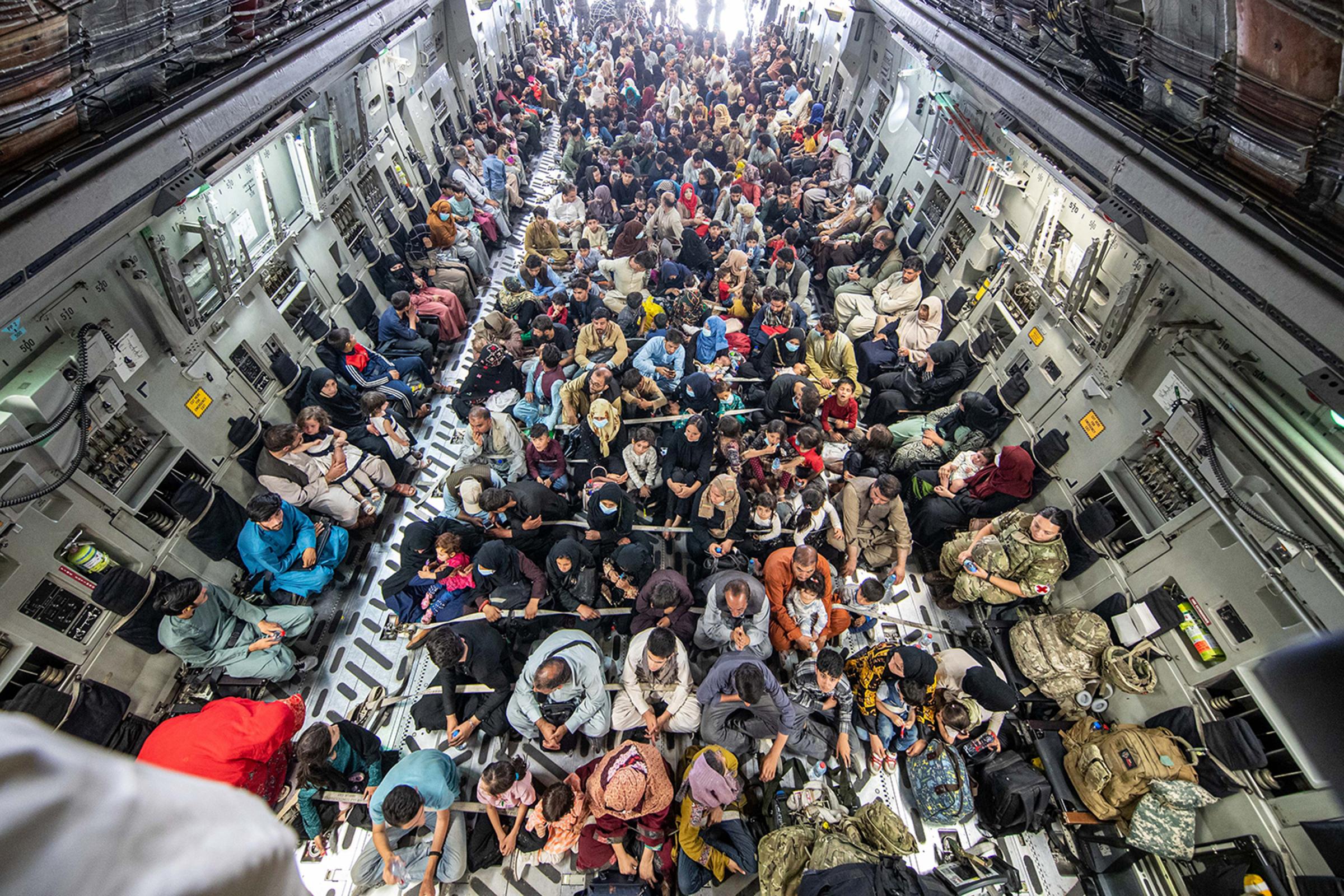 A full flight of 265 people supported by members of the UK Armed Forces on board an evacuation flight out of Kabul airport Picture: PA