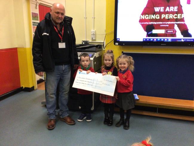 Jessie is presented a cheque for the foundation from members of the school council