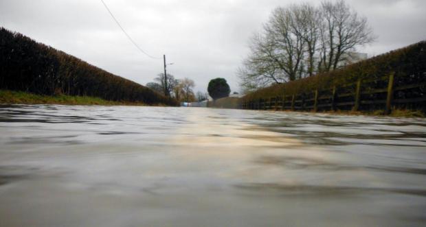 South Wales Guardian: The road into Llangadog near the creamery is submerged underwater Picture: Stuart Ladd