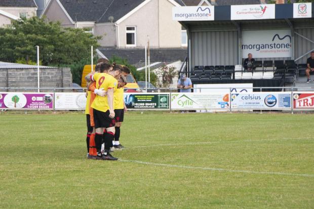 South Wales Guardian: Mumbles Rangers in the pre-match minutes silence. Picture: Naomi Newman