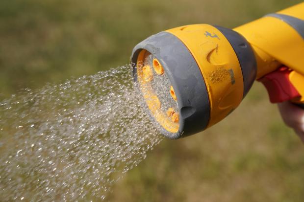 A UK minister has urged water companies to ban hosepipes. (Picture: PA Wire)