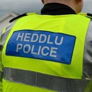 Two Ammanford residents have been charged with offences against police officers.