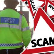 A fake police officer is targeting residents in the Carmarthenshire area
