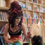 Drag Queen Aida H. Dee captivating kids in one of her story readings.