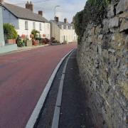 The stone wall at this pedestrian pinch-point on High Street, St Clears, will be taken back in order to widen the pavement as part of planning consent for 64 homes nearby (pic by Carmarthenshire Council and free for use for all BBC wire partners)