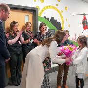 Sofia Davies, 8, hands the Princess of Wales with a bouquet of flowers.