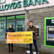 Welsh Liberal Democrats Jane Dodd and  David Chadwick outside Lloyds Bank.