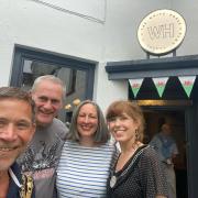 Ifor Ap Glyn (second left) stopped off at Llandeilo's White Horse on his literary walk through Wales. Picture: Christoph Fischer