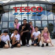 Jordan Banjo with school children outside Tesco launching the new Stronger Start scheme. Picture: Tesco
