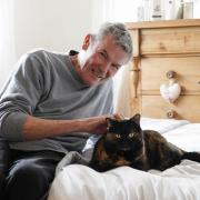 David Cryer and his cat Beau who reached the final of Marvellous Moggy in the Cats Protection National Cat Awards. Picture: PA Media