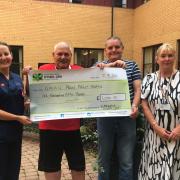 Henry and Roy Owen (centre) presenting cheque to unit at Prince Philip Hospital. Picture: Hywel Dda Health Charities