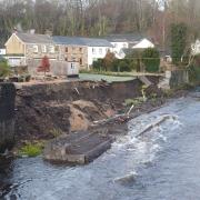 Part of the retaining wall has collapsed into the river Tawe.