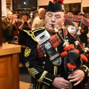 Pipe Major Michael Kelly leading the piping of the haggis.