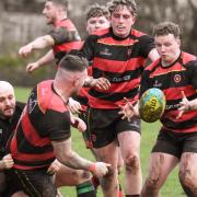 Penybanc RFC get the ball away during clash with Seven Sisters.