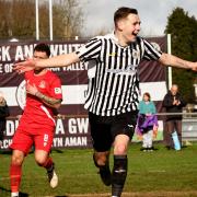 Lewis Reed celebrates after scoring the winner for Ammanford AFC