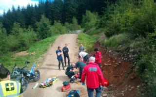The mountain biker being treated by medics following high high speed crash