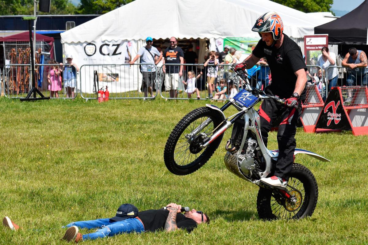 - The Xtreme Stunt team's Dan Clarke jumps his motorcycle over commentator Paul Evers.  Pic Mark Davies